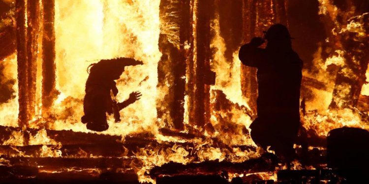 burning man jumps fire video